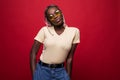 Terrific african model expressing surprised emotions while posing on indoor photoshoot. Stylish curly woman in sunglasses having Royalty Free Stock Photo