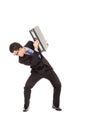 Terrified businessman using briefcase to protect.