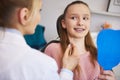 Terrified girl looking at female orthodontist Royalty Free Stock Photo