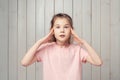 Terrified little girl having anxious stressed out look, holding hands near face, feeling danger, received bad news Royalty Free Stock Photo