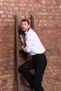 Terrified man trapped at the top of a ladder Royalty Free Stock Photo