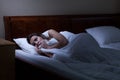 Terrified woman lying in bed Royalty Free Stock Photo