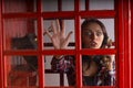 Terrified woman trapped in a telephone booth