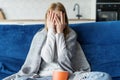 Terrified woman watching horror movie on TV alone