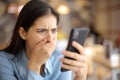Terrified woman watching media content on phone