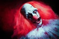 Terrifying clown on dark background. Halloween party costume