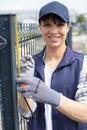 territory enclosure - worker installing metal fence Royalty Free Stock Photo