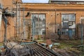 The territory of an old abandoned factory littered with dismantled metal structures. Dangerous place in an neglected plant