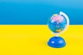 Territory of Russia on the map, globe Ukrainian flag background blue and yellow. Stop war.
