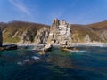 A huge stone in the form of an arch stands in the middle of the sea against the background of sheer cliffs. The territory of the