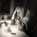 Woman with candles. Power outage in Kyiv