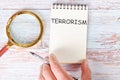 TERRORISM written on a blank sheet of a notebook Royalty Free Stock Photo
