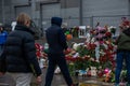 People carry flowers, candles, toys to a spontaneous memorial near the Crocus City Hall building