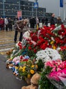 People carry flowers, candles, toys to a spontaneous memorial near the Crocus City Hall building