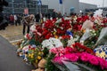 People carry flowers, candles, toys to a spontaneous memorial near the Crocus City Hall building