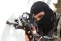 Terrorist in black mask with a gun