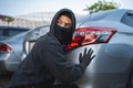 Terrorist or car thief in black mask with car. robbery and crime concept Royalty Free Stock Photo