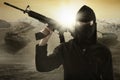 Terrorist with gun and military vehicle Royalty Free Stock Photo