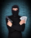 Terrorist holding gun and dollars