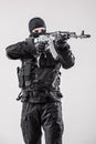 Terrorist holding a machine gun in his hands aim isolated over white