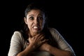 Terrorized and horrified woman desperate and scared isolated on black