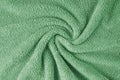 Terry cloth, green towel texture background. Soft fluffy textile bath or beach towel material Royalty Free Stock Photo