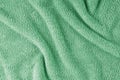 Terry cloth, green towel texture background. Soft fluffy textile bath or beach towel material Royalty Free Stock Photo