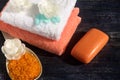 Terry fresh towels, a bar of fragrant soap, bath salt lie on a wooden surface. Royalty Free Stock Photo