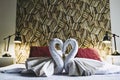 Terry towels folded in the shape of a swan on the bed of a hotel room Royalty Free Stock Photo