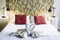 Terry towels folded in the shape of a swan on the bed of a hotel room Royalty Free Stock Photo