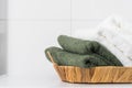 Terry towels in wooden basket in bathroom