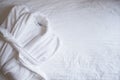 Terry white bathrobe on the bed, with space for text, top view. The concept of rest in a hotel Royalty Free Stock Photo