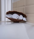 Terry white and brown towels in a wicker basket Royalty Free Stock Photo