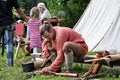 TERVETE, LATVIA - AUGUST 13, 2011: Historical Zemgalu days. Unknown man in ancient dress sits on a bench and repairing ancient