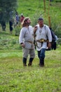 TERVETE, LATVIA - AUGUST 13, 2011: Historical Zemgalu days. Unknown men in historical dress standing in the meadow and talking