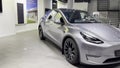 Tesla car model Y in liquid silver dubbed Mercury Silver Metallic color in Studio, electric vehicle in showroomr, alternative