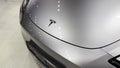 Tesla car model Y in liquid silver dubbed Mercury Silver Metallic color in Studio, electric vehicle in showroomr, alternative