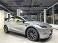 Tesla car model Y in liquid silver dubbed Mercury Silver Metallic color in Studio, electric vehicle in showroomr, alternative