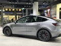 Tesla car model Y in liquid silver dubbed Mercury Silver Metallic color in Studio, electric vehicle in showroomr, alternative