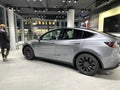 Tesla car model Y in liquid silver dubbed Mercury Silver Metallic color in Studio, electric vehicle in showroomr, alternative