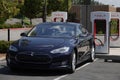 Tesla Car at a Public EV Charging Station During the Day