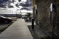 A Tesla level 2 charger mounted to an outside wall for EV charging at a Days Inn Hotel.