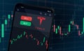 Tesla logo on mobile phone screen - shares rise or fall on stock exchange market Royalty Free Stock Photo