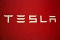 Tesla logo on red cloth Royalty Free Stock Photo