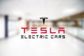 Tesla logo the window of the electric cars showroom