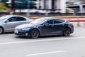 Tesla Model S on the city road. All-electric five-door liftback sedan in motion Royalty Free Stock Photo