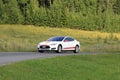 Tesla Model S Electric Car and Green Rural Road Royalty Free Stock Photo