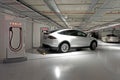 Tesla plug-in electric car Model X been charged by a Supercharge