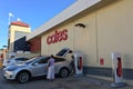 Tesla plug-in electric car Model X been charged by a Supercharger network in Coles Supercharger station