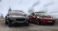 Tesla is a red car and Jaguar is a black car. Royalty Free Stock Photo